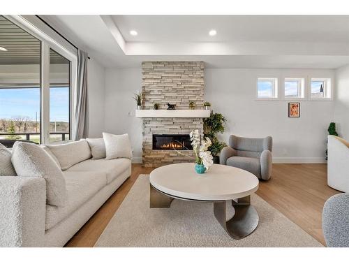 135 Clear Creek Place, Rural Rocky View County, AB - Indoor Photo Showing Living Room With Fireplace