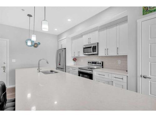 303-4150 Seton Drive Se, Calgary, AB - Indoor Photo Showing Kitchen With Stainless Steel Kitchen With Double Sink With Upgraded Kitchen