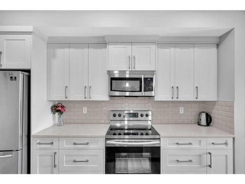 303-4150 Seton Drive Se, Calgary, AB - Indoor Photo Showing Kitchen With Stainless Steel Kitchen With Upgraded Kitchen