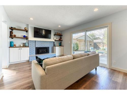 712 Lake Lucerne Drive Se, Calgary, AB - Indoor Photo Showing Living Room With Fireplace
