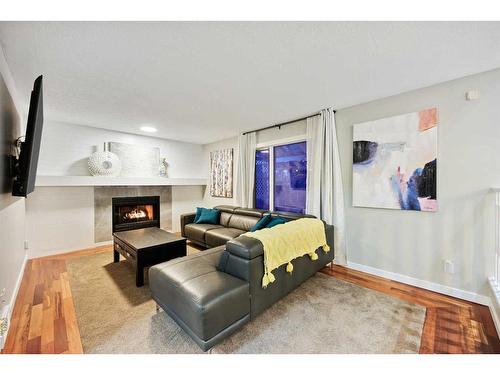 612 Meadowbrook Bay Se, Airdrie, AB - Indoor Photo Showing Living Room With Fireplace