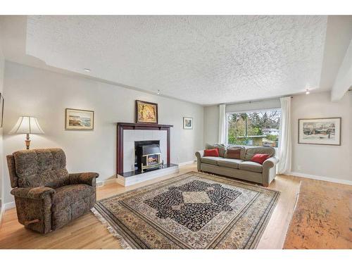 47 Rosetree Road Nw, Calgary, AB - Indoor Photo Showing Living Room With Fireplace