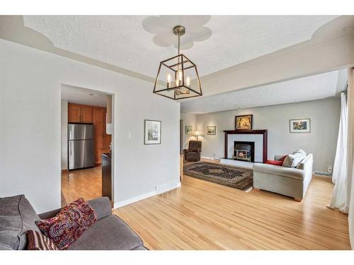 47 Rosetree Road Nw, Calgary, AB - Indoor Photo Showing Living Room With Fireplace