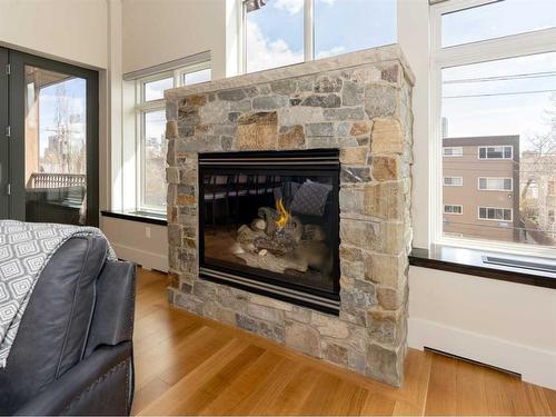 303-1407 Kensington Close Nw, Calgary, AB - Indoor Photo Showing Living Room With Fireplace