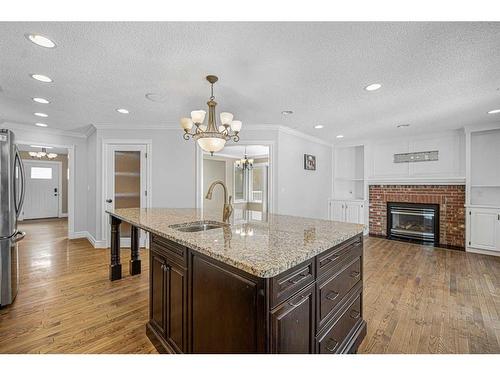 256 Sirocco Place, Calgary, AB - Indoor Photo Showing Kitchen With Fireplace With Upgraded Kitchen