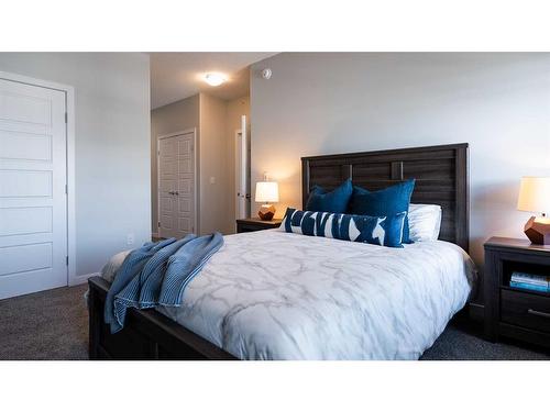 208-404 1 Avenue Se, Diamond Valley, AB - Indoor Photo Showing Bedroom