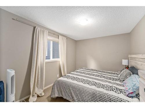 40 Sunrise View, Cochrane, AB - Indoor Photo Showing Bedroom