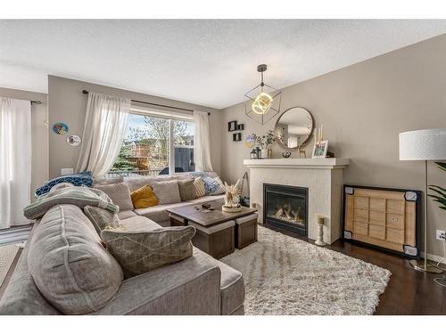 40 Sunrise View, Cochrane, AB - Indoor Photo Showing Living Room With Fireplace
