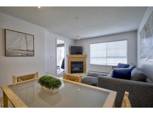231-22 Richard Place Sw, Calgary, AB - Indoor Photo Showing Living Room With Fireplace