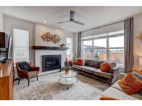 11 Arbour Lake Heights Nw, Calgary, AB - Indoor Photo Showing Living Room With Fireplace