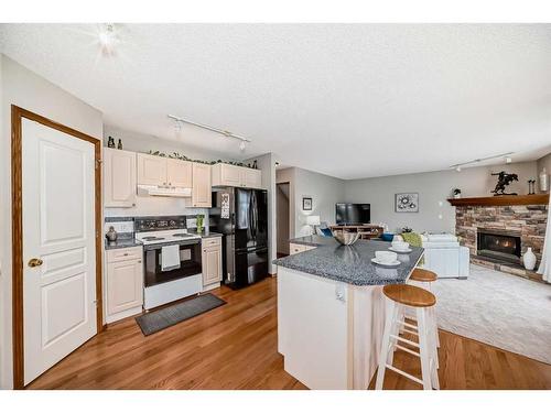 250 Somerside Green Sw, Calgary, AB - Indoor Photo Showing Kitchen With Fireplace