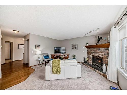 250 Somerside Green Sw, Calgary, AB - Indoor Photo Showing Living Room With Fireplace