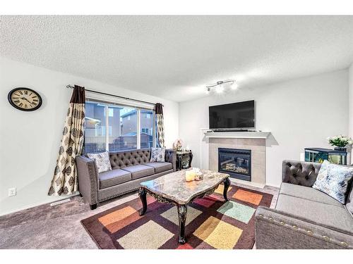 114 Saddlecrest Crescent Ne, Calgary, AB - Indoor Photo Showing Living Room With Fireplace