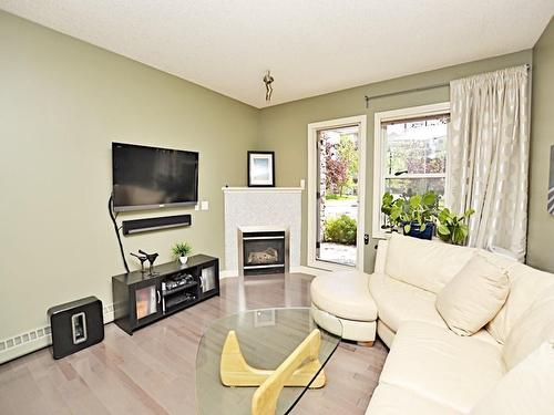 107-1408 17 Street Se, Calgary, AB - Indoor Photo Showing Living Room With Fireplace