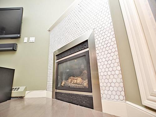 107-1408 17 Street Se, Calgary, AB - Indoor Photo Showing Other Room With Fireplace