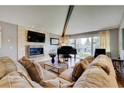 11 Woodlark Drive Sw, Calgary, AB - Indoor Photo Showing Living Room With Fireplace