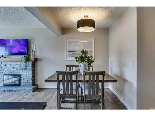 133 Pantego Lane Nw, Calgary, AB - Indoor Photo Showing Dining Room With Fireplace