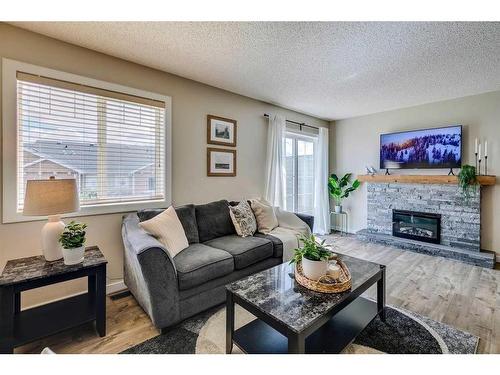 133 Pantego Lane Nw, Calgary, AB - Indoor Photo Showing Living Room With Fireplace