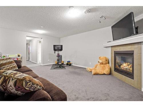 1363 New Brighton Park Se, Calgary, AB - Indoor Photo Showing Living Room With Fireplace