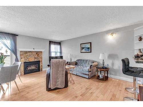 247-54 Glamis Green Sw, Calgary, AB - Indoor Photo Showing Living Room With Fireplace