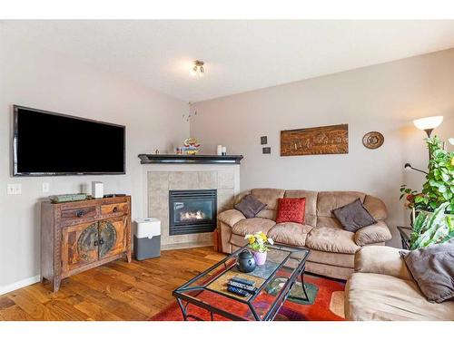 193 Royal Crest View Nw, Calgary, AB - Indoor Photo Showing Living Room With Fireplace