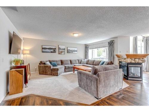 25 Cranston Drive Se, Calgary, AB - Indoor Photo Showing Living Room With Fireplace