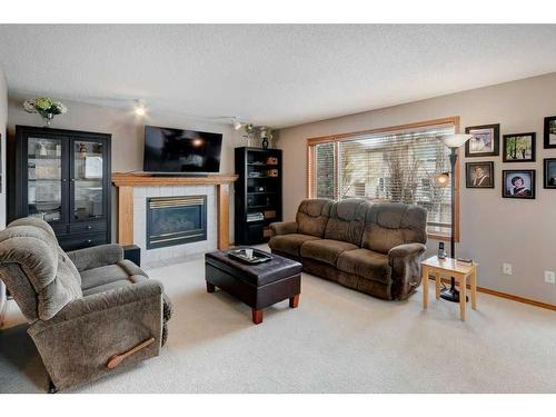 135 Hidden Circle Nw, Calgary, AB - Indoor Photo Showing Living Room With Fireplace