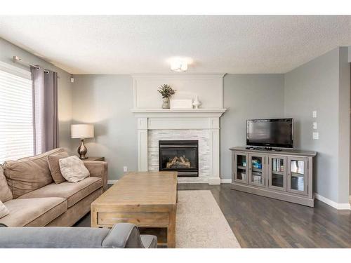 106 Cougar Plateau Way Sw, Calgary, AB - Indoor Photo Showing Living Room With Fireplace