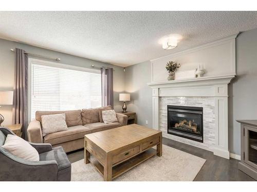 106 Cougar Plateau Way Sw, Calgary, AB - Indoor Photo Showing Living Room With Fireplace