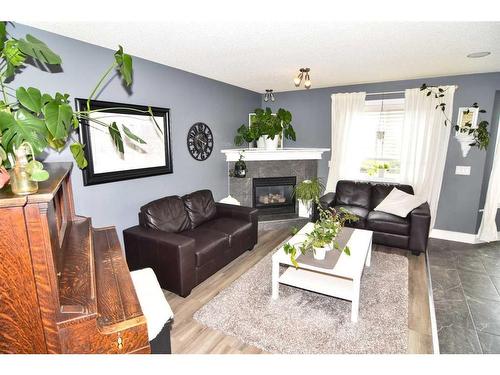 244 Tarawood Place Ne, Calgary, AB - Indoor Photo Showing Living Room With Fireplace