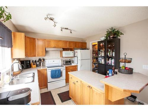 1747 High Country Drive Nw, High River, AB - Indoor Photo Showing Kitchen With Double Sink