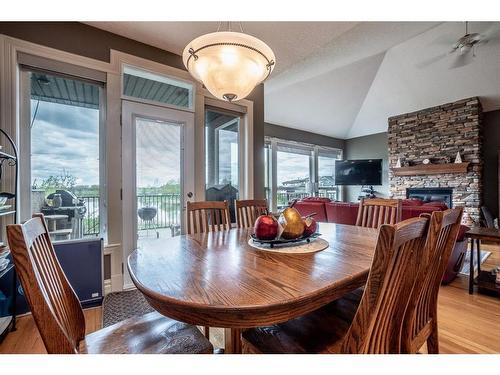 1611 Sunshine Way Se, High River, AB - Indoor Photo Showing Dining Room With Fireplace