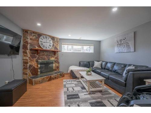 16 Templeridge Close Ne, Calgary, AB - Indoor Photo Showing Living Room With Fireplace