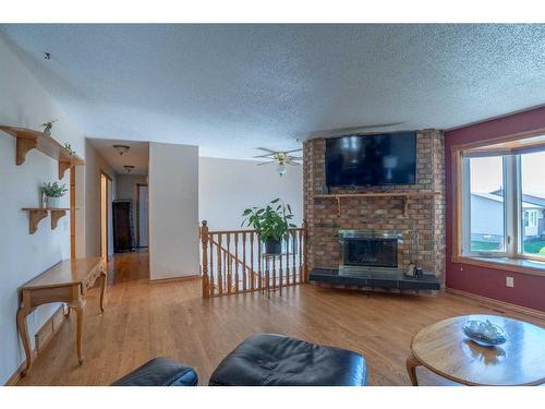 16 Templeridge Close Ne, Calgary, AB - Indoor Photo Showing Living Room With Fireplace