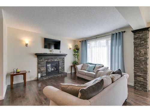 31 West Coach Road Sw, Calgary, AB - Indoor Photo Showing Living Room With Fireplace