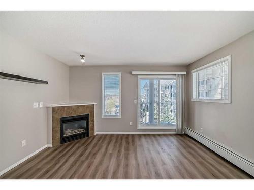 1306-5 Country Village Park Ne, Calgary, AB - Indoor Photo Showing Living Room With Fireplace