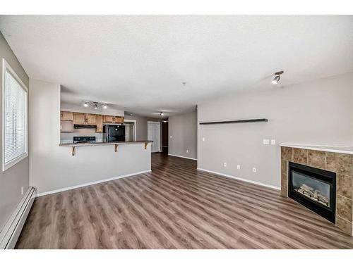 1306-5 Country Village Park Ne, Calgary, AB - Indoor Photo Showing Living Room With Fireplace