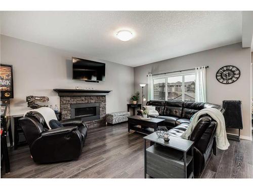 245 Bayside Loop Sw, Airdrie, AB - Indoor Photo Showing Living Room With Fireplace