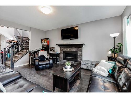 245 Bayside Loop Sw, Airdrie, AB - Indoor Photo Showing Living Room With Fireplace