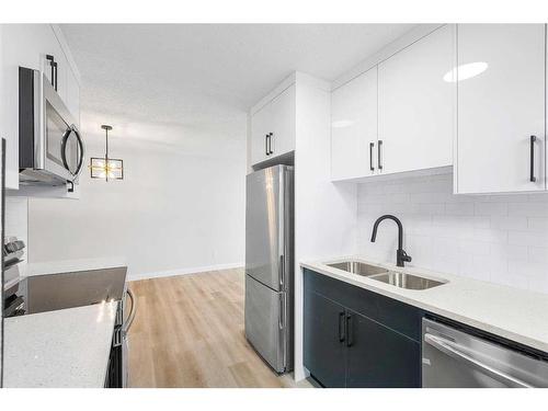7645 21A Street Se, Calgary, AB - Indoor Photo Showing Kitchen With Stainless Steel Kitchen With Double Sink With Upgraded Kitchen