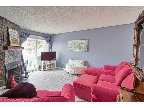 58-3800 Fonda Way Se, Calgary, AB - Indoor Photo Showing Living Room With Fireplace