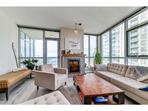 1205-99 Spruce Place Sw, Calgary, AB - Indoor Photo Showing Living Room With Fireplace