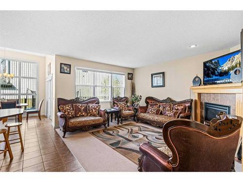 137 Copperleaf Bay Se, Calgary, AB - Indoor Photo Showing Living Room With Fireplace