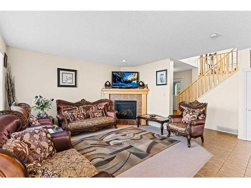 137 Copperleaf Bay Se, Calgary, AB - Indoor Photo Showing Living Room With Fireplace