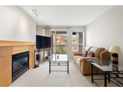 321-5115 Richard Road Sw, Calgary, AB - Indoor Photo Showing Living Room With Fireplace