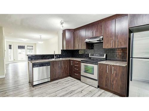 1906-2445 Kingsland Road Se, Airdrie, AB - Indoor Photo Showing Kitchen With Stainless Steel Kitchen