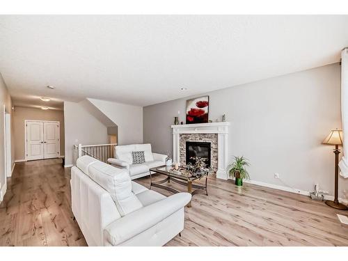 17 Riviera Place, Cochrane, AB - Indoor Photo Showing Living Room With Fireplace