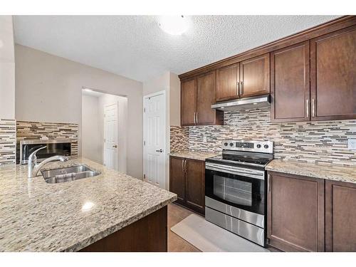 104 Windstone Mews Sw, Airdrie, AB - Indoor Photo Showing Kitchen With Upgraded Kitchen