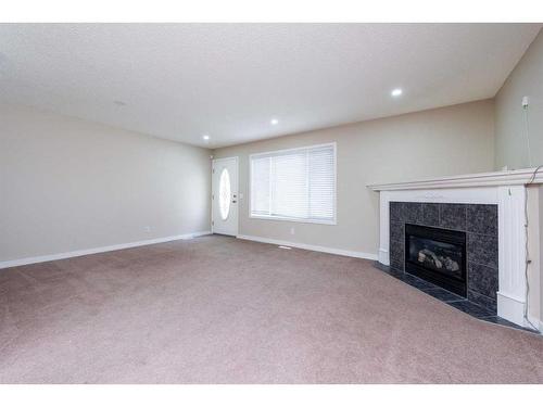 319 Coral Cove Ne, Calgary, AB - Indoor Photo Showing Living Room With Fireplace