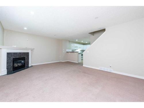 319 Coral Cove Ne, Calgary, AB - Indoor With Fireplace